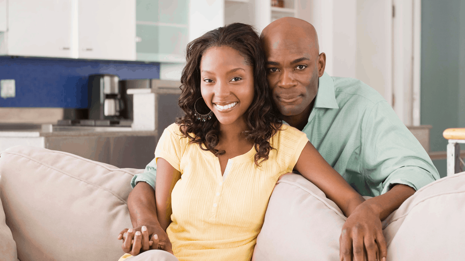 A happy black couple looks into the camera, they are also considering receiving acupuncture in Richmond, VA. 