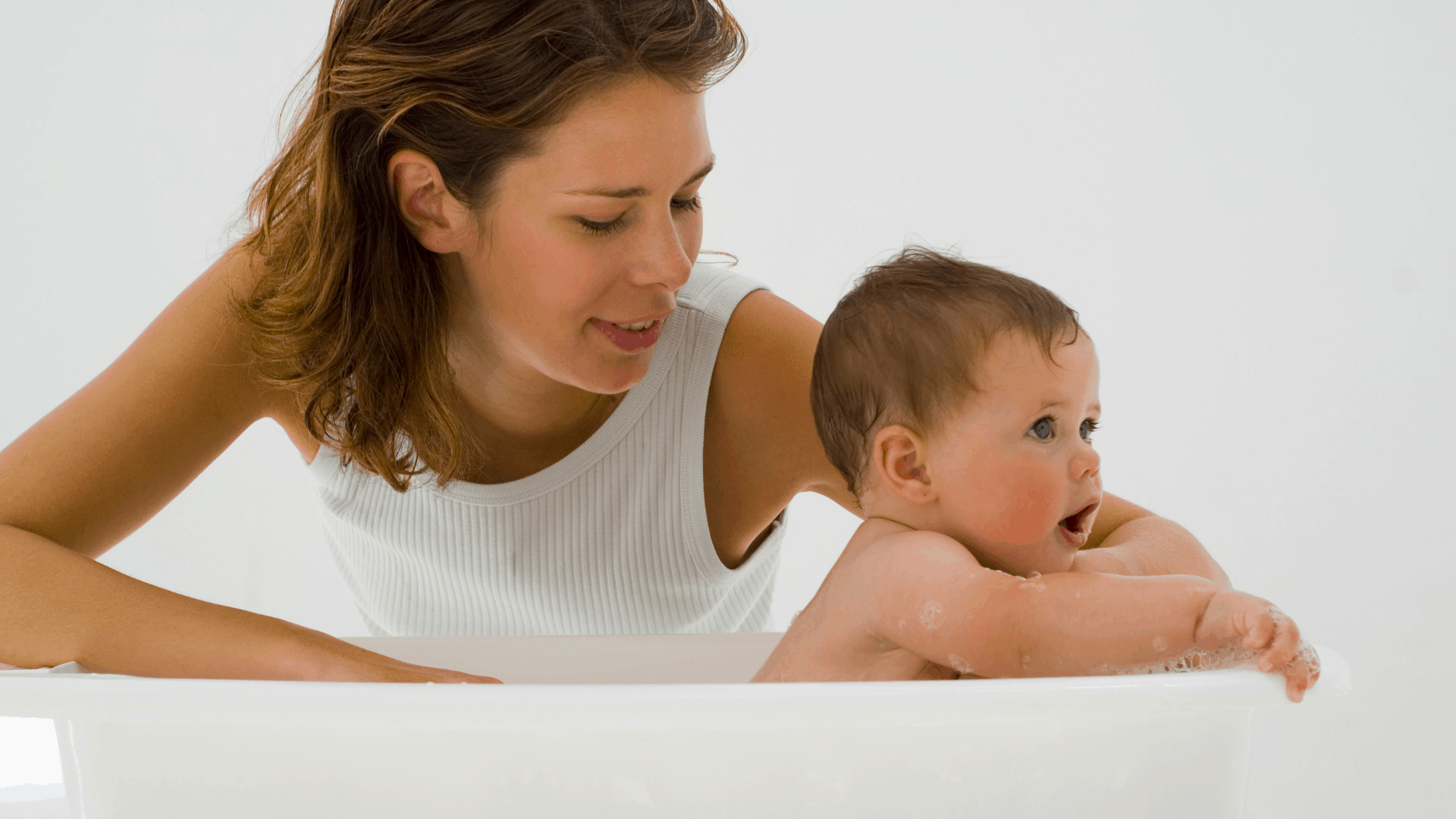 A mom bathes her newborn. 