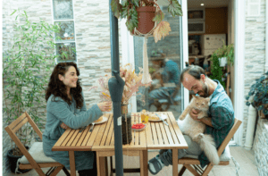 Two people sit at a table and discuss using acupuncture for depression with a cat on the lab.