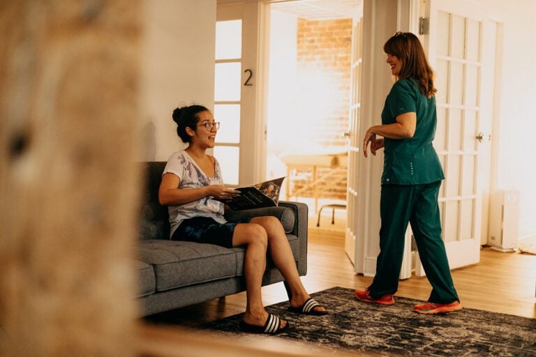 Maegan N. Hodge prepares to discuss MCAS and acupuncture with a patient after greeting in the waiting room.