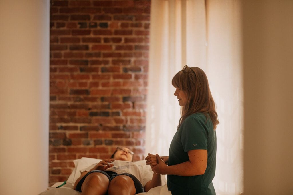 Maegan N. Hodge, L.Ac. takes pulse before acupuncture treatment.